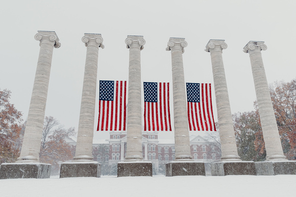 Mizzou-Columns-American-Flags-Snow